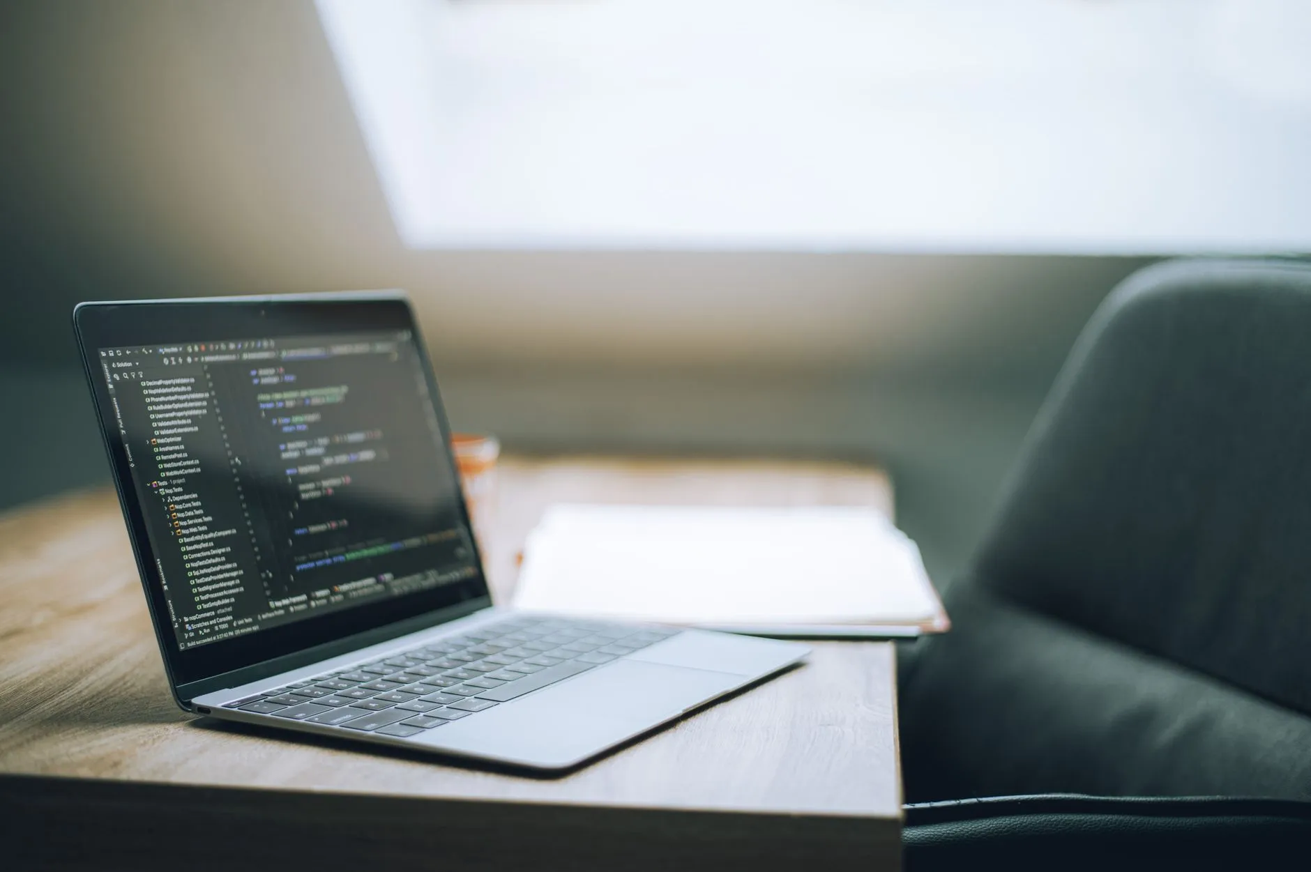Modern development workspace with source code displayed on a laptop